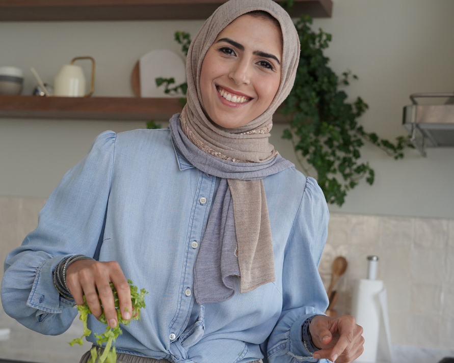 Arwa smiling in a kitchen