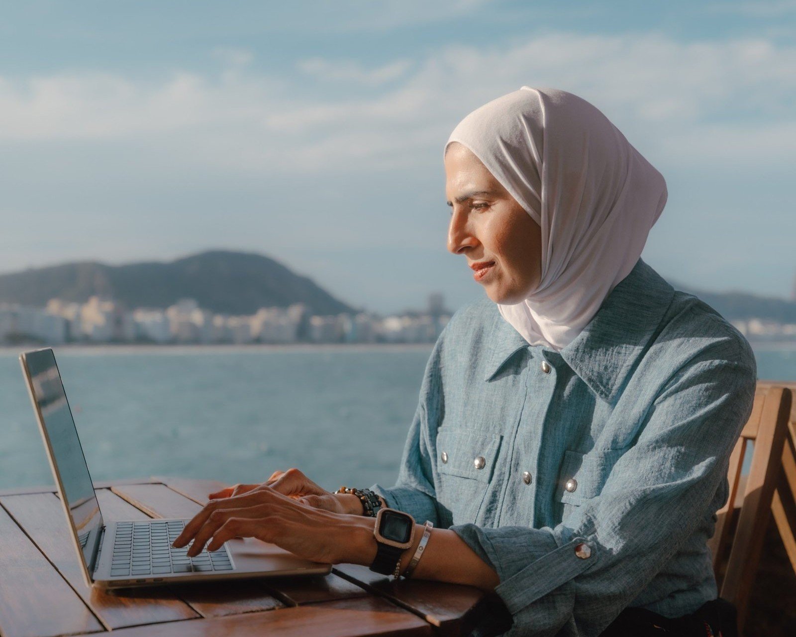 Woman writing notes by the water